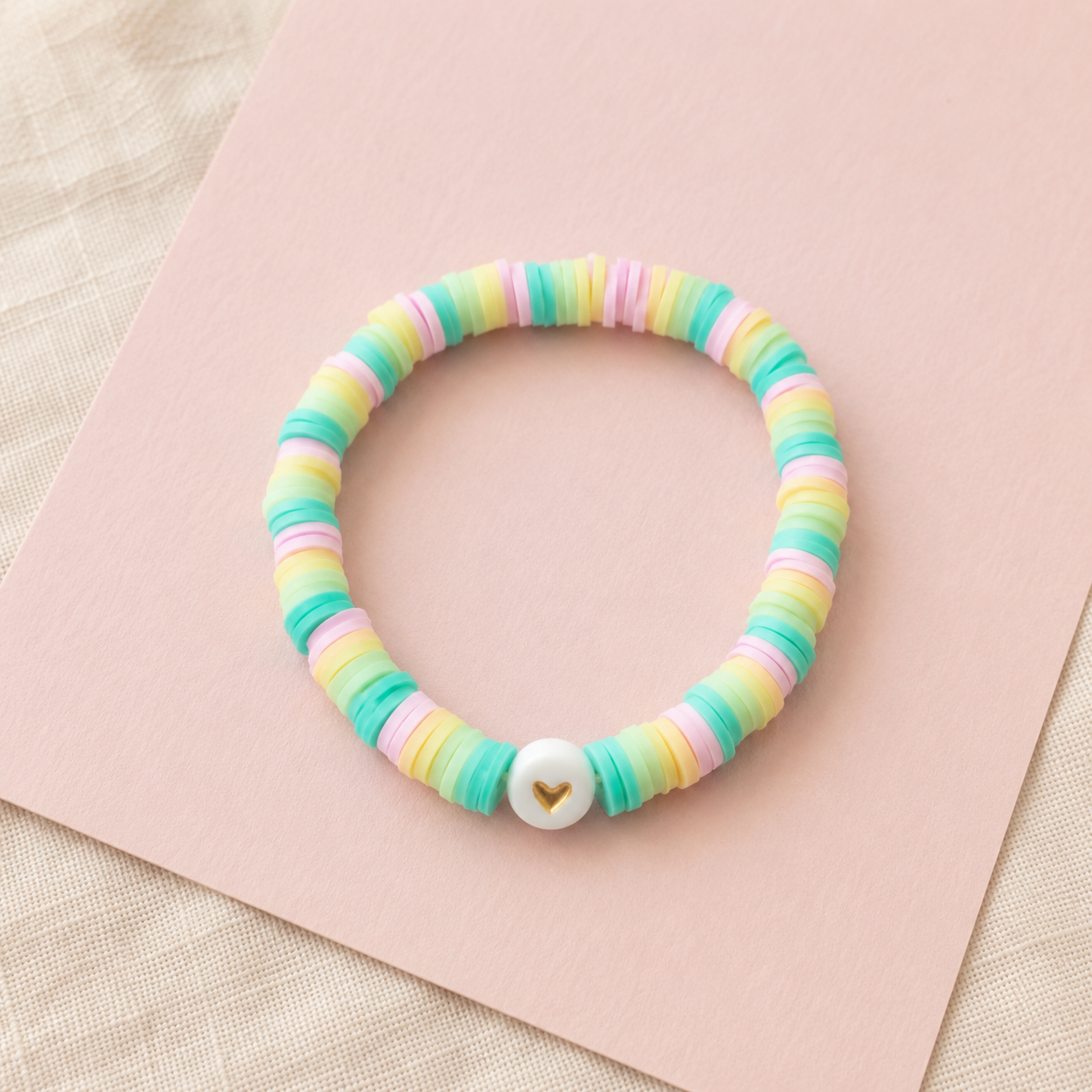 Pastel rainbow clay bracelet with gold heart bead